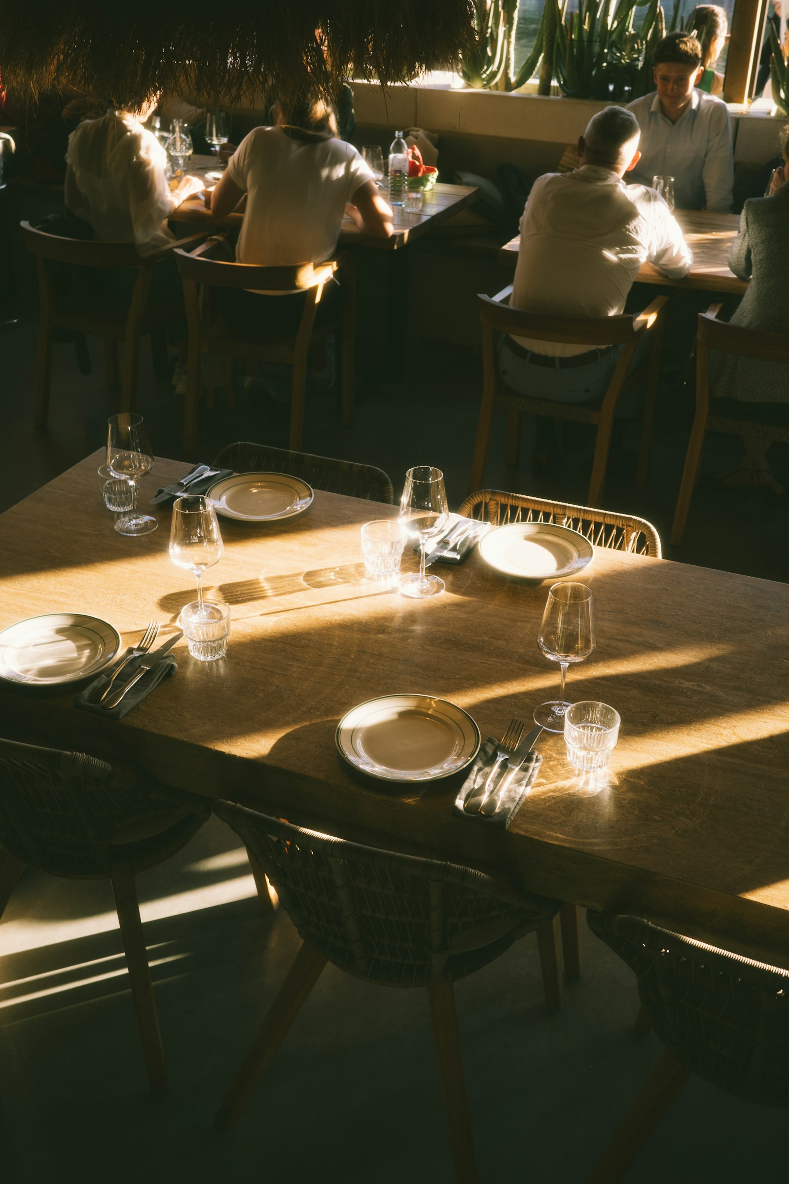 A sunlit dining room with members at lunch