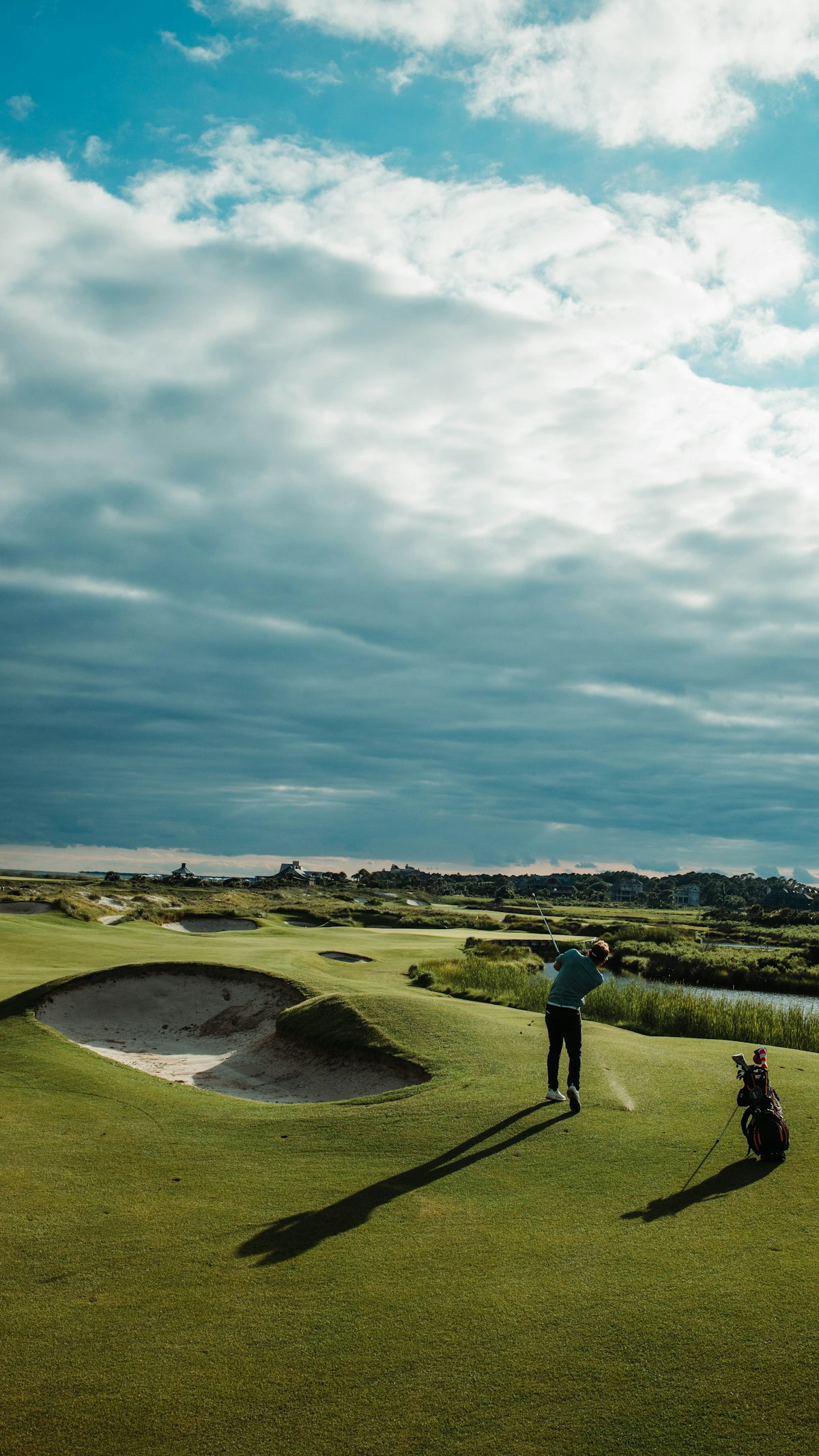A golfer finishing a swing on the fairway